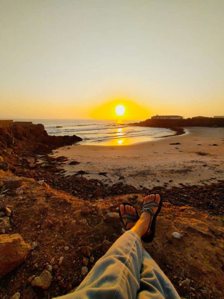 Watching the sun setting by the beach.