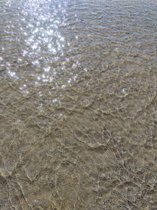Water reflecting on a sand beach