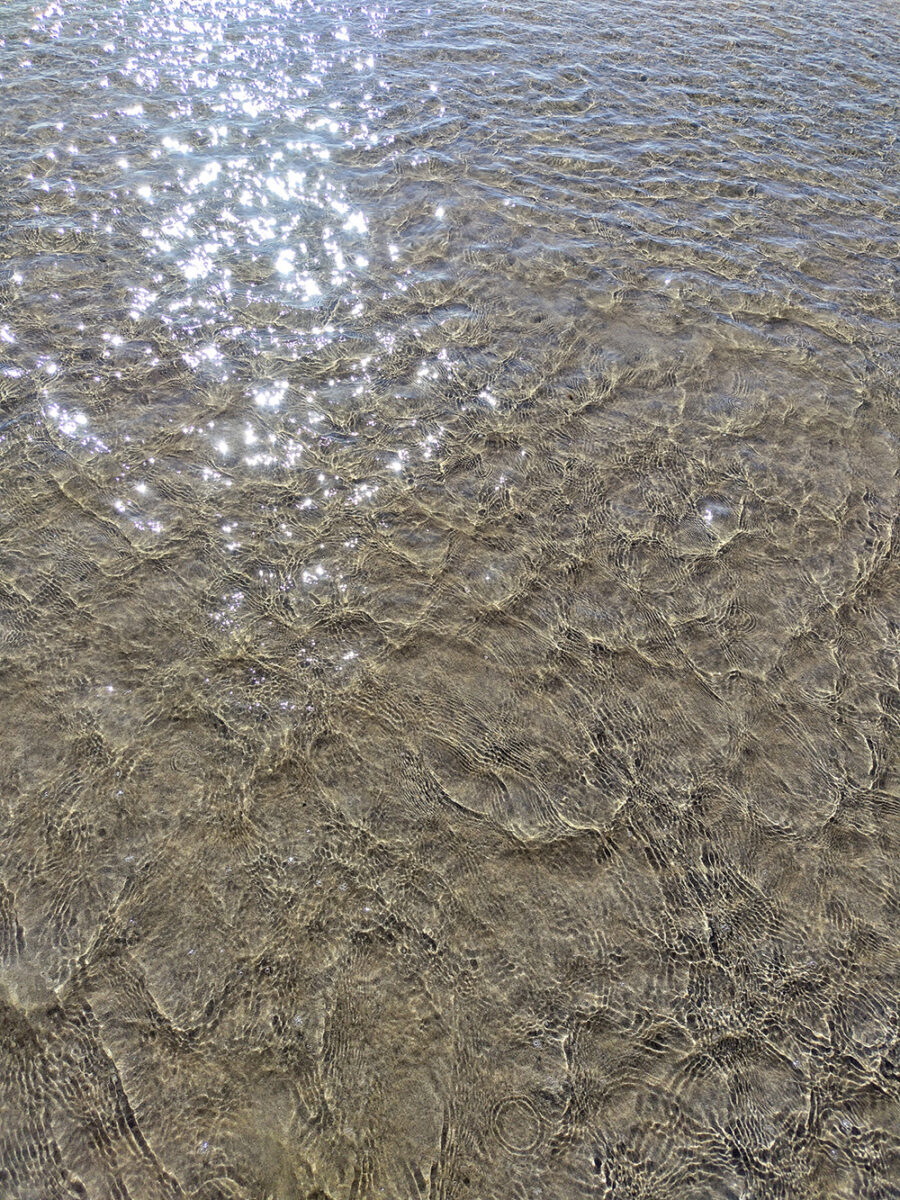 Water reflecting on a sand beach